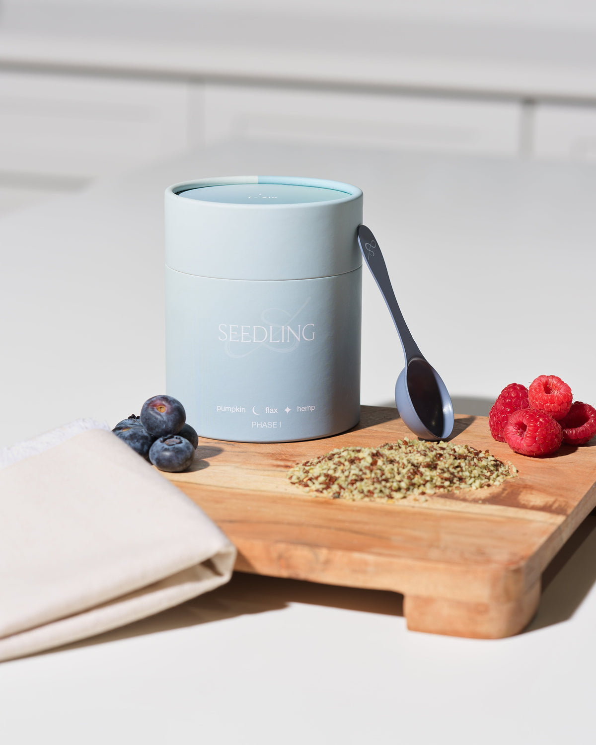 flax, pumpkin, sesame, and sunflower seeds arranged by cycle phase", "Her Seedling seed cycling kit on marble counter"
